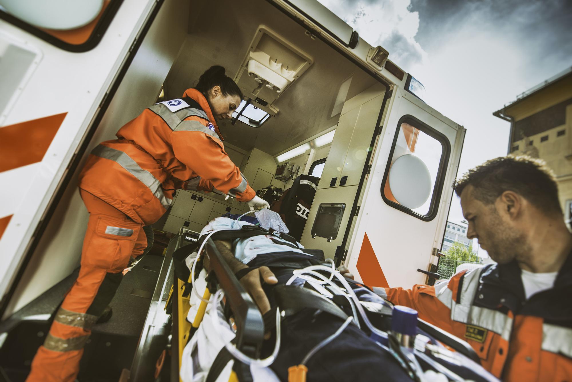 paramedic team pushing stretcher